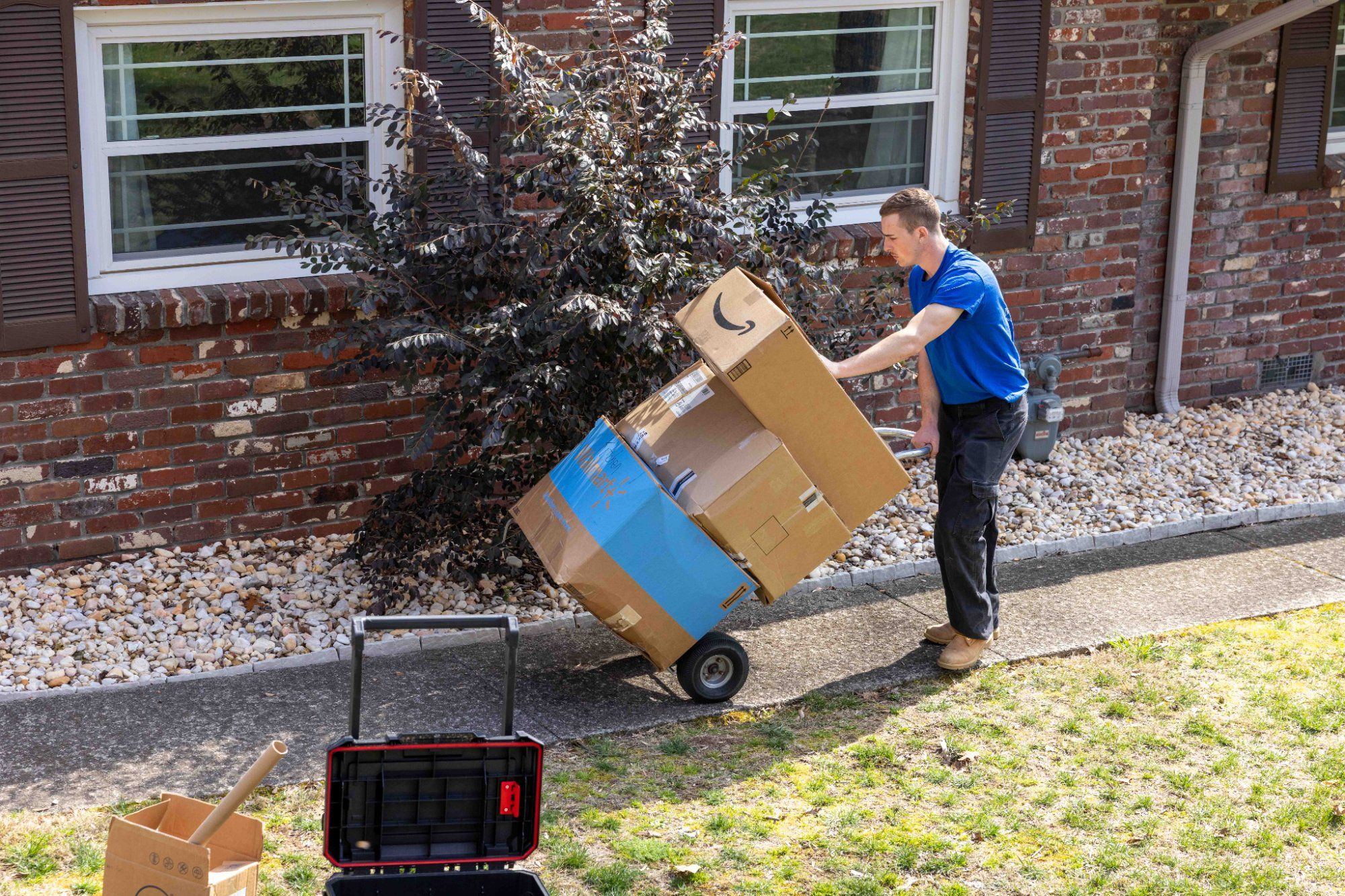 Midas Touch senior movers carrying a padded dresser up stairs with care during a senior move in Knoxville Tennessee