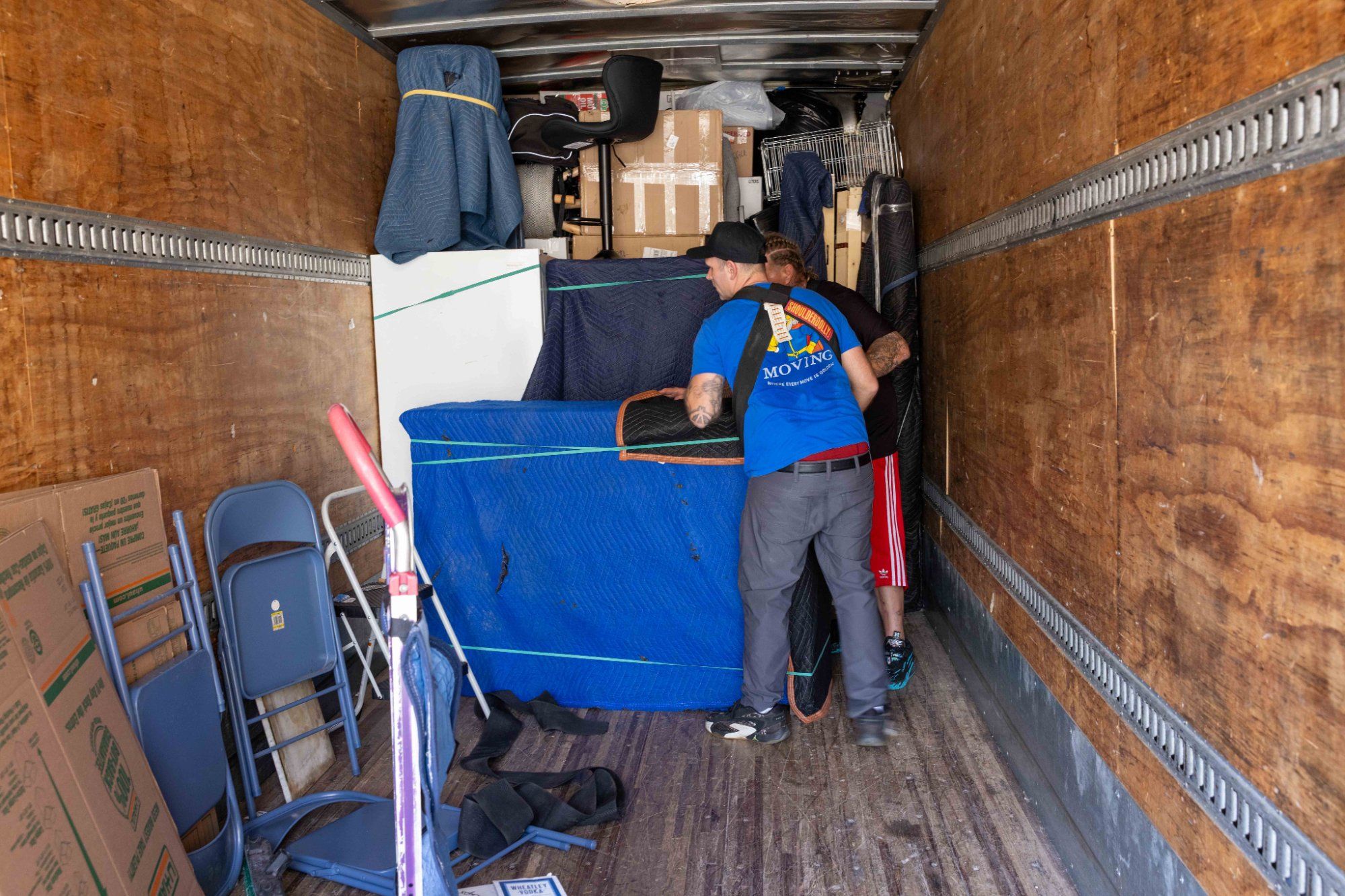 Midas Touch Moving crew securing furniture with straps and moving blankets inside the truck for a long distance move from Sevierville TN