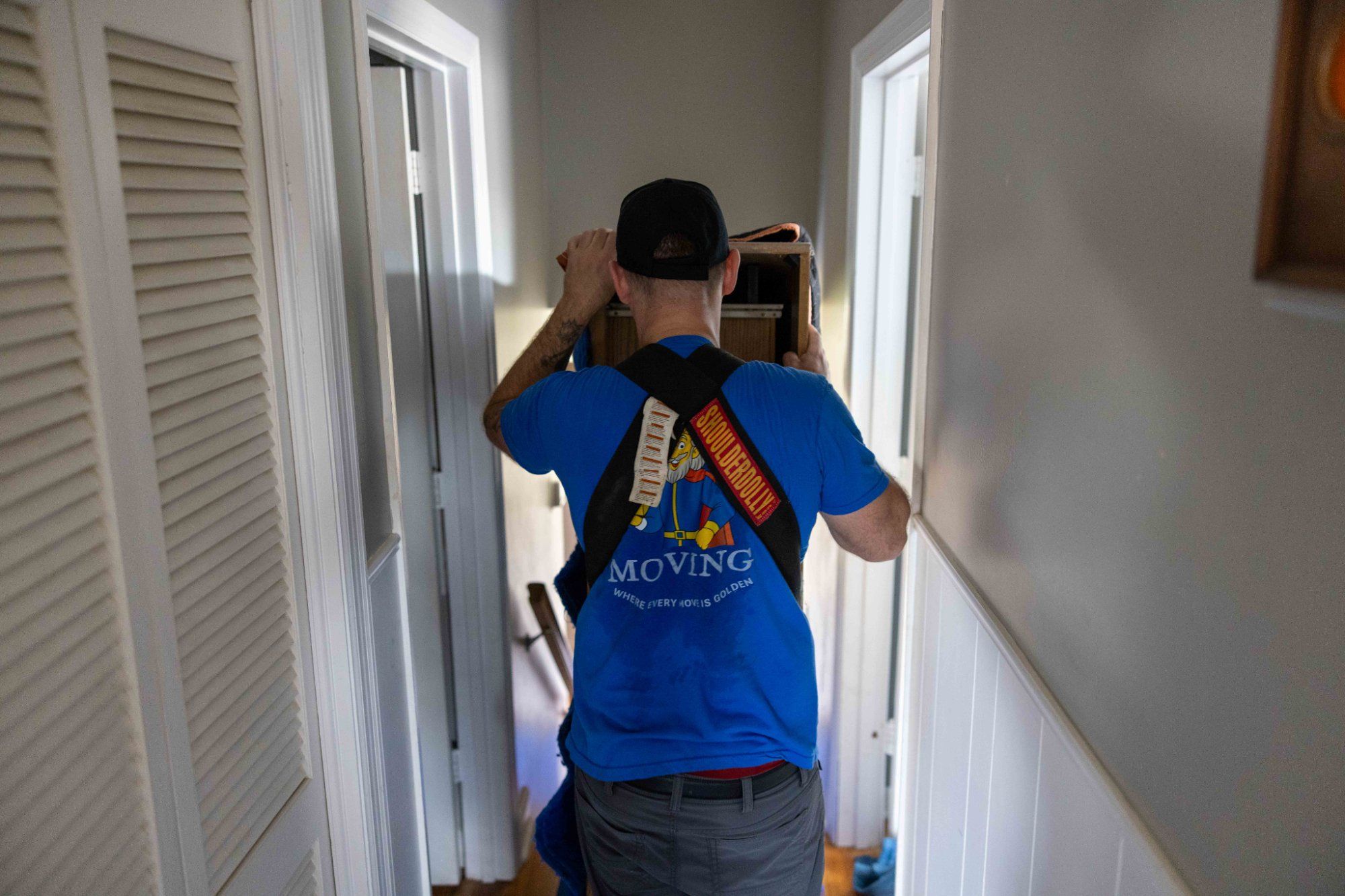 Midas Touch labor only movers navigating furniture through a tight hallway during a move in Sevierville Tennessee