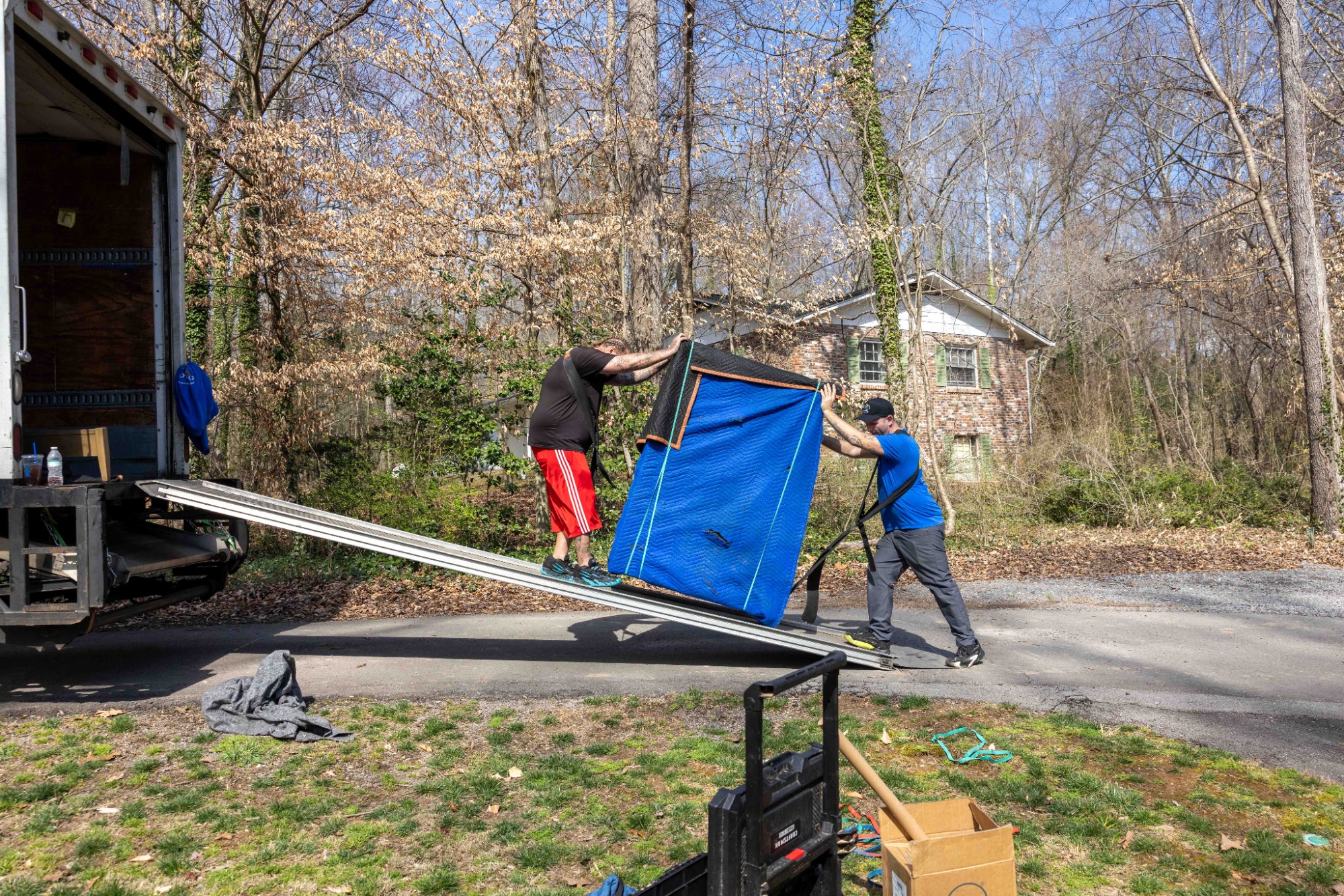 Midas Touch movers loading padded furniture up the truck ramp during a Sevierville Tennessee move